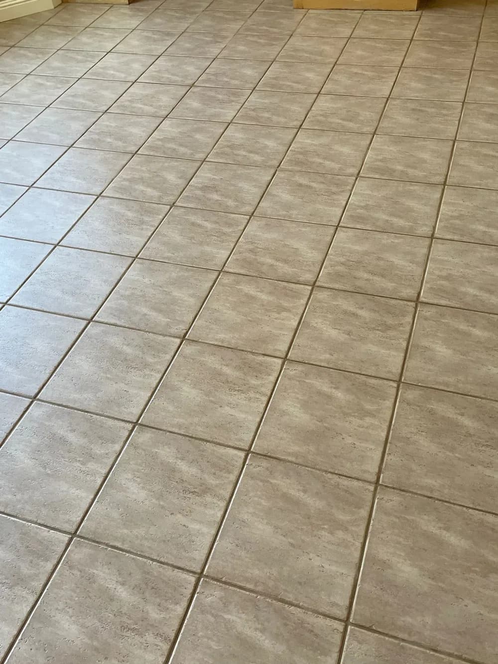 Clean tile floor with fresh grout lines after cleaning